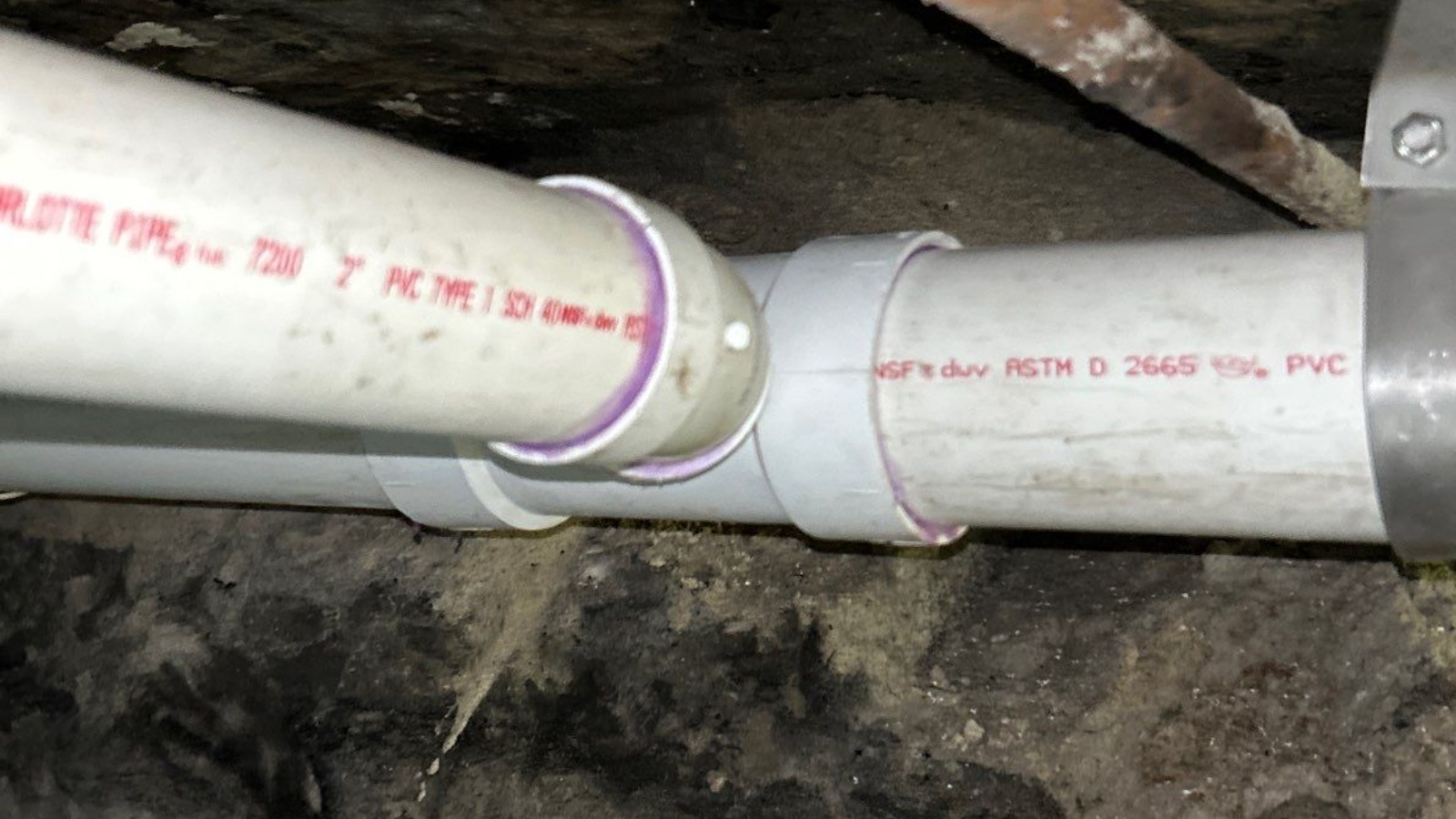 Cast Iron Replacement — Washington Street, Hollywood — after: Horizontal branch drain and laundry branch drain combo fitting connection beneath the foundation — rotted cast iron with holes and missing sections replaced with PVC